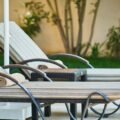Outdoor patio furniture set with cushioned loungers on a backyard patio