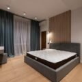 Memory foam mattress on an upholstered bed frame in a modern bedroom