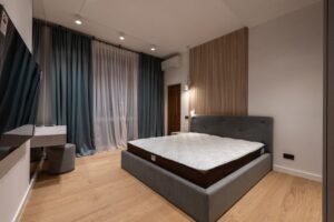 Memory foam mattress on an upholstered bed frame in a modern bedroom