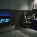 Room with smart LED light strip backlight glowing behind a TV and desk setup