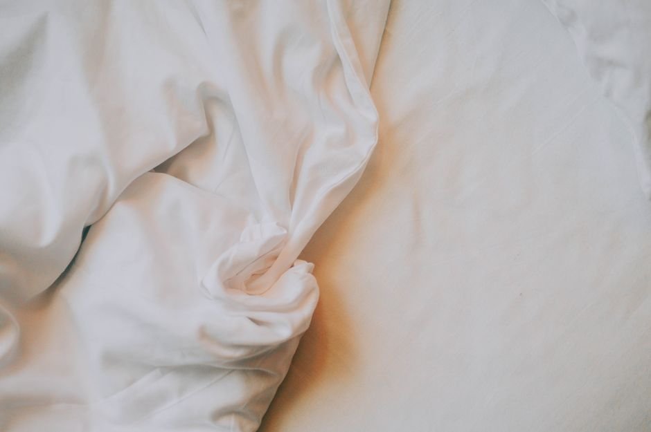Fresh soft bed sheets on a comfortable bed