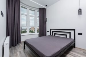 Blackout curtains keeping a cozy bedroom dark for better sleep