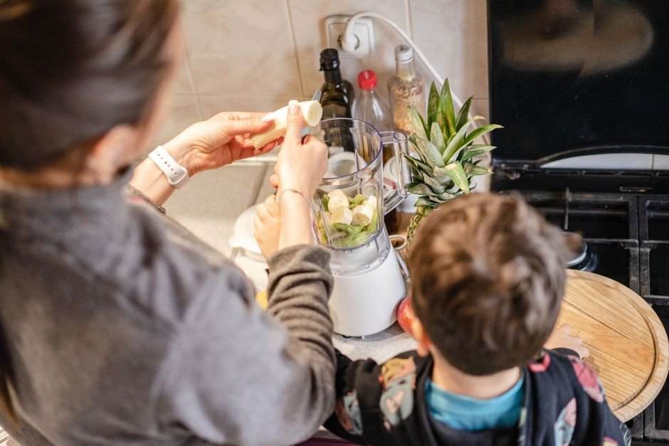 Blender making a fresh fruit smoothie in a modern kitchen