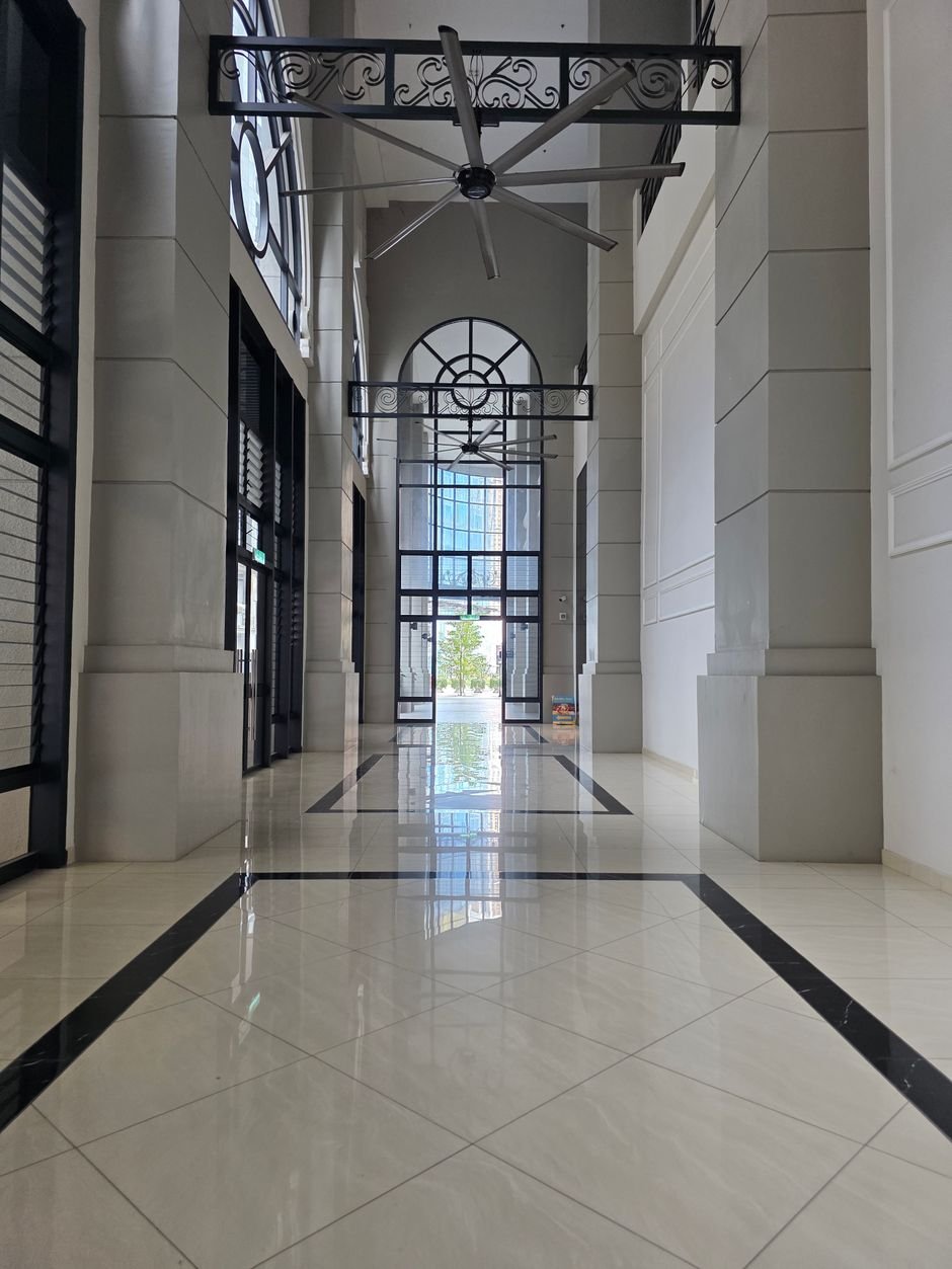 Large HVLS ceiling fans moving air in a high-ceiling hall