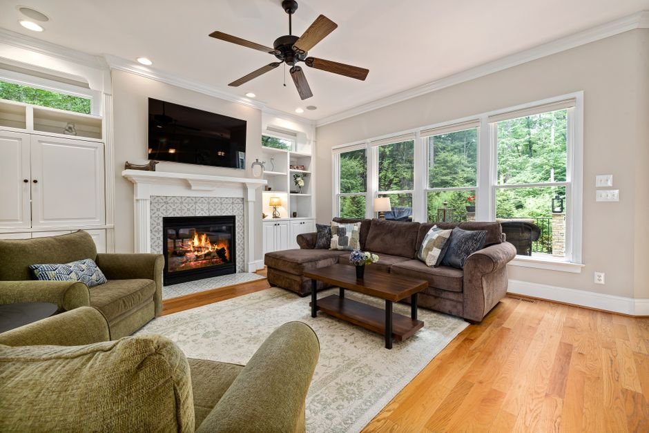 Modern living room with a ceiling fan running above the sofa