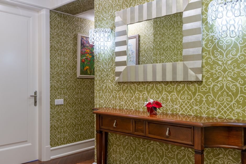 Ornamental patterned wallpaper in a styled entryway