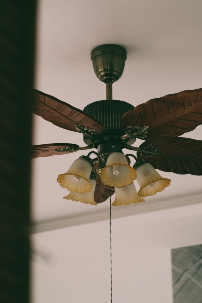 Ornate ceiling fan with a warm light kit