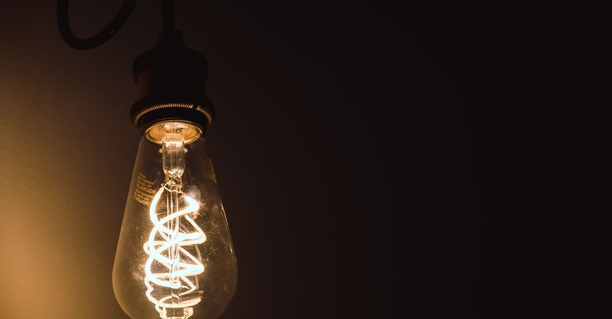 Warm Edison bulb glowing against a dark background