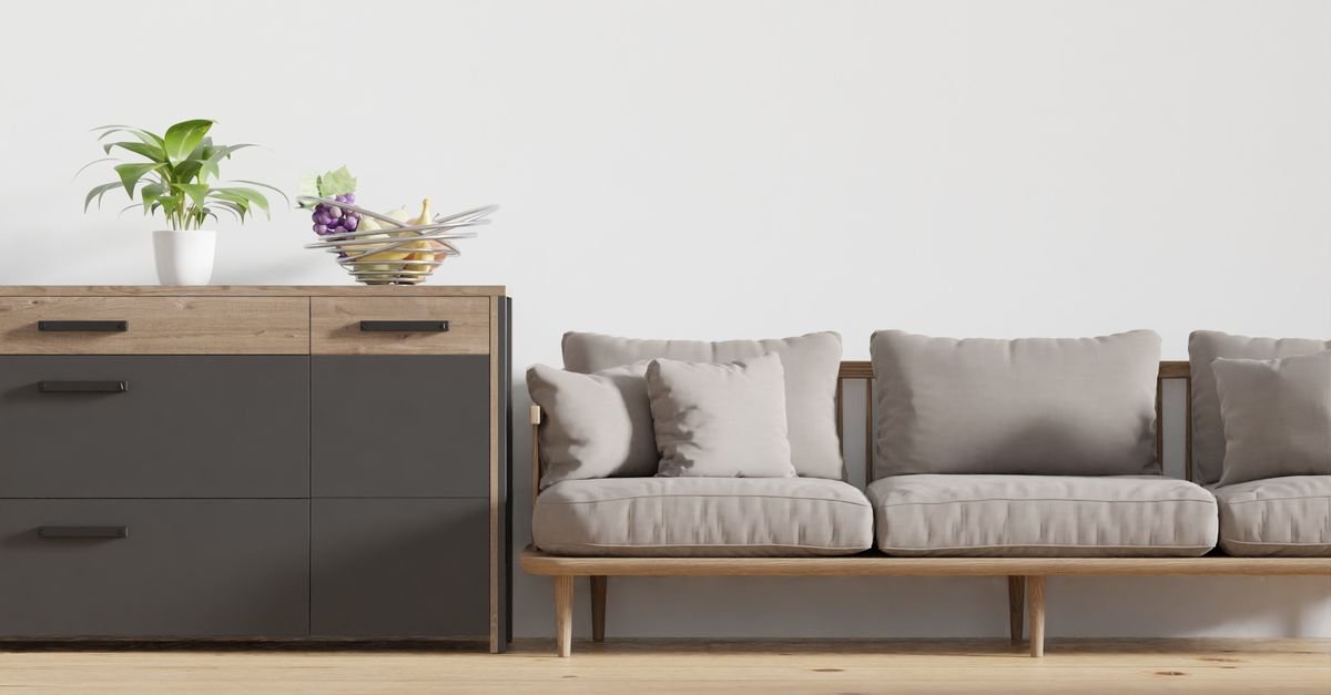 A light wood console beside a sofa with pale wood legs