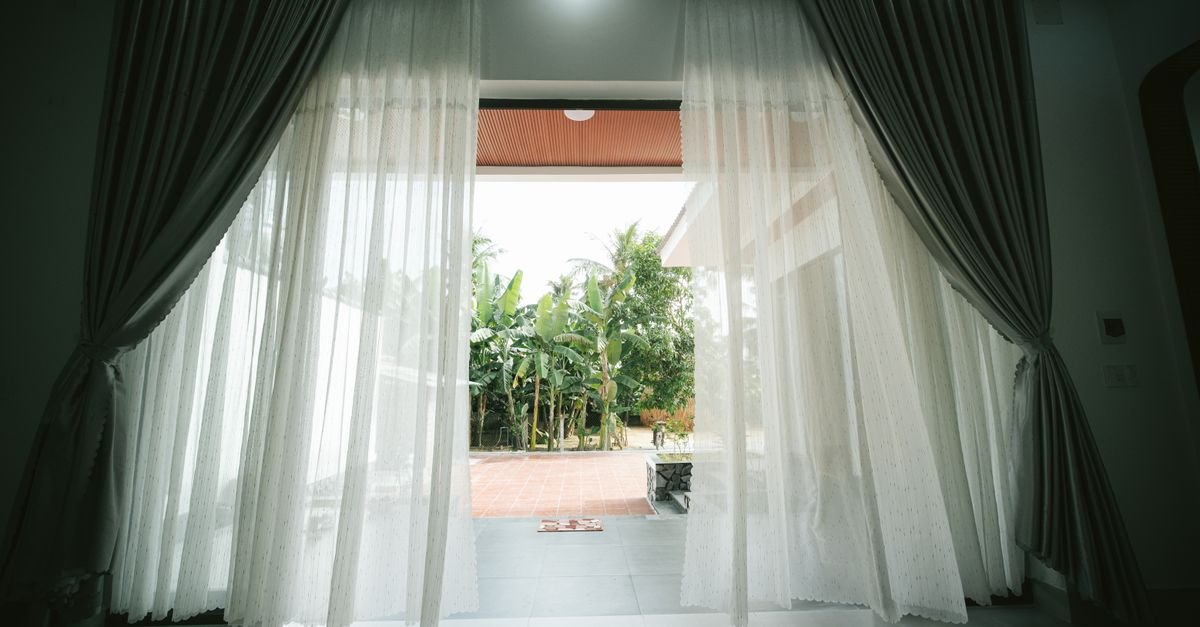 Open doorway with sheer curtains letting fresh air in