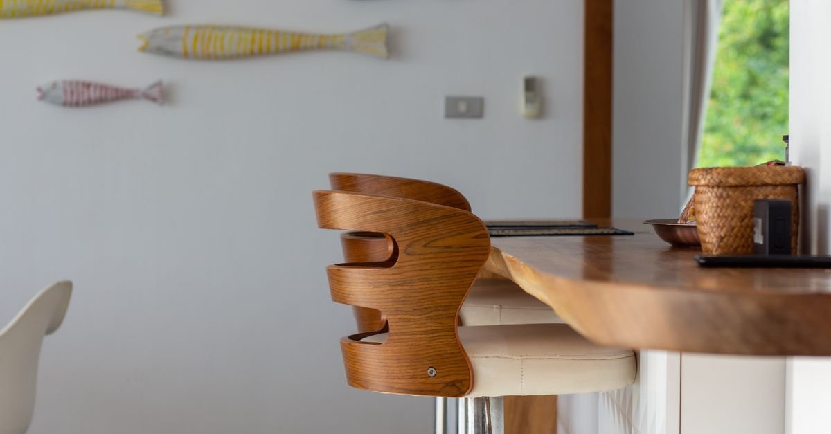 A wooden bar stool at a kitchen counter