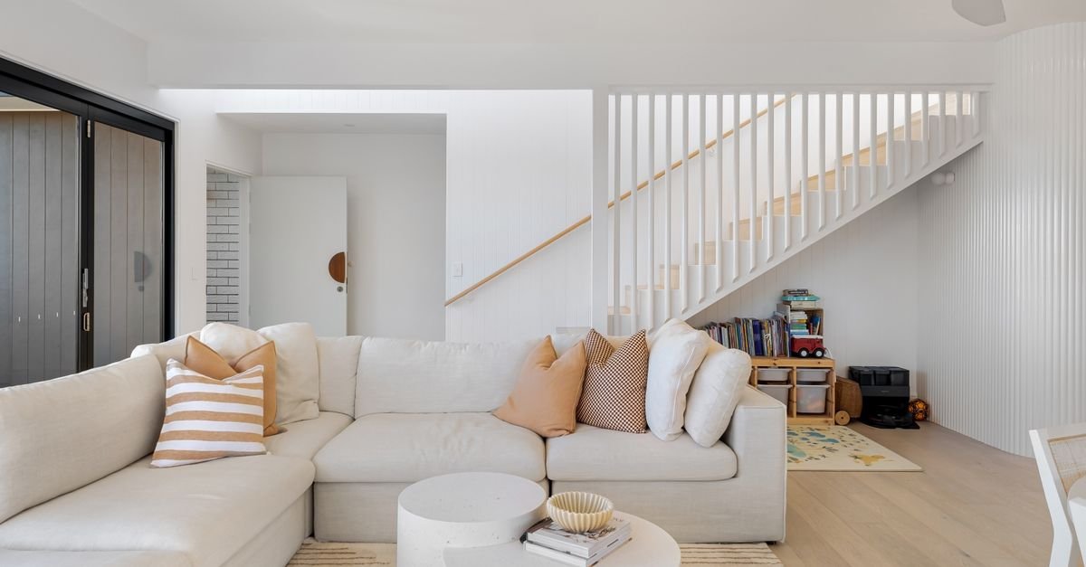 A bright cream living room with a large sectional