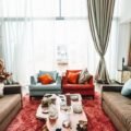 A layered living room mixing several wood tones with textiles