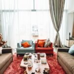 A layered living room mixing several wood tones with textiles