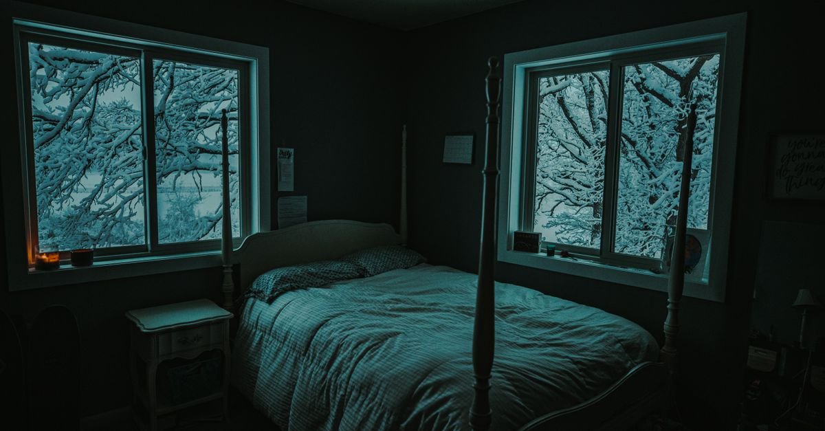 A dark, cozy bedroom for better sleep