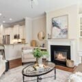 A bright living room with styled built-in shelves beside a fireplace