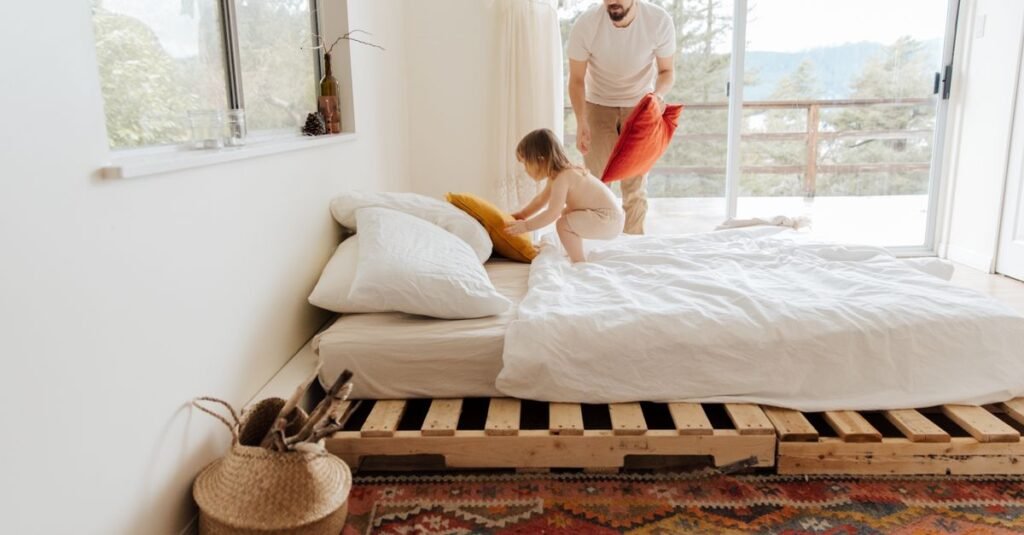 Parent and toddler on a low floor bed