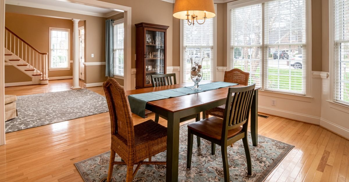 A dark wood dining table and chairs on a lighter wood floor