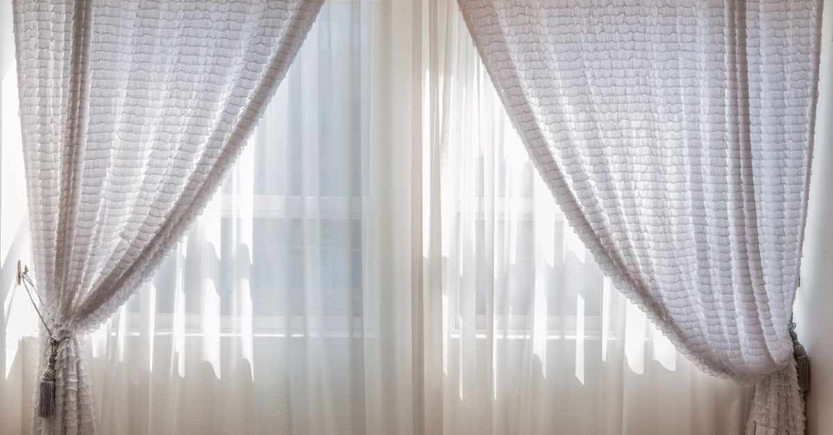 Sheer white curtains letting light into a room
