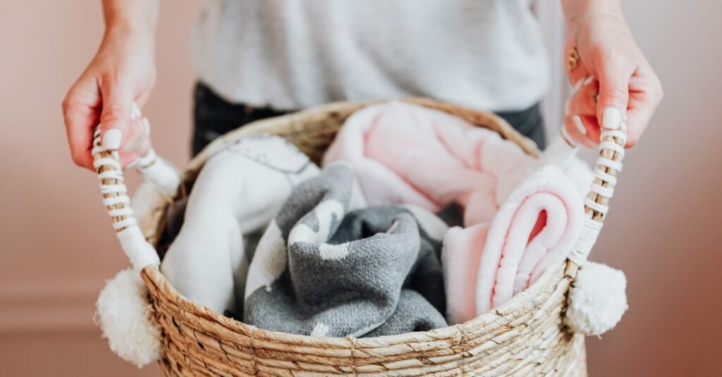 Carrying a basket of rolled baby blankets