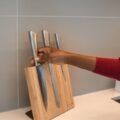 Placing kitchen knives into a wooden block