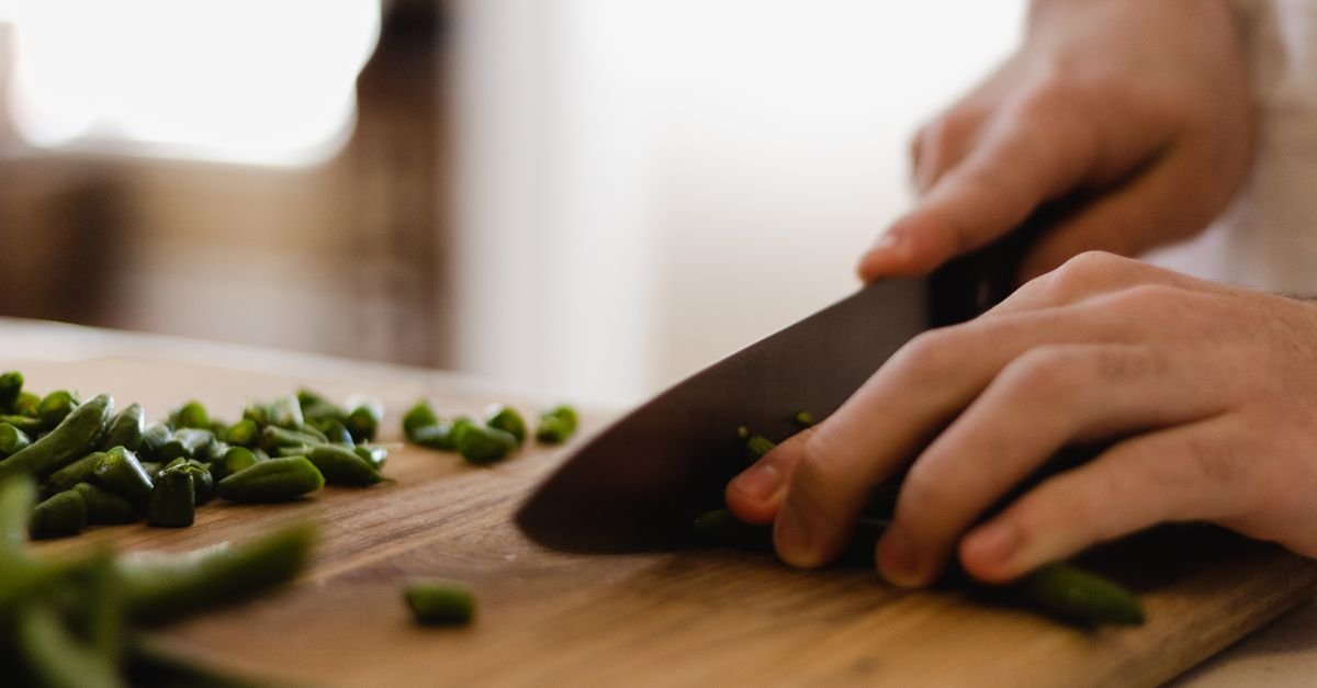 A sharp chef knife slicing cleanly