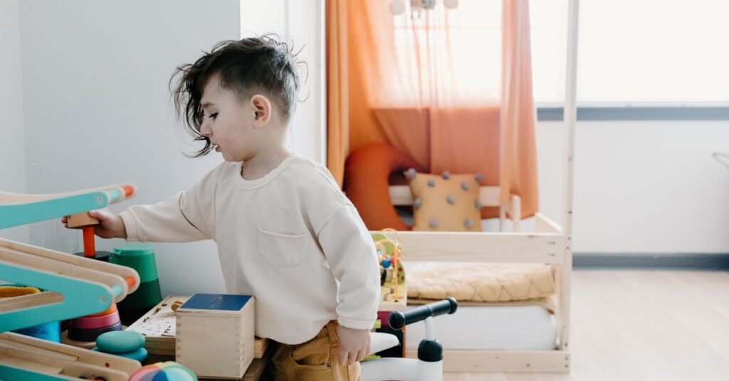 Toddler climbing on low wooden play furniture