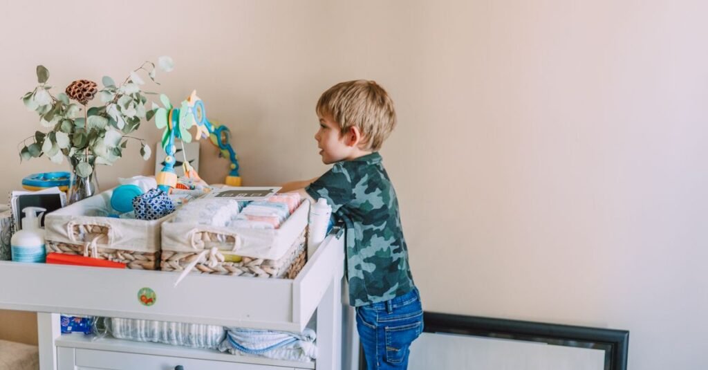 Toddler reaching into an organized changing station