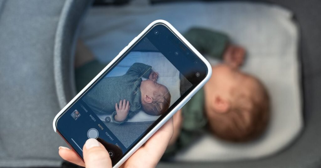 Phone screen monitoring a sleeping newborn