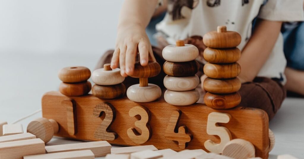 Small hands exploring wooden counting toys