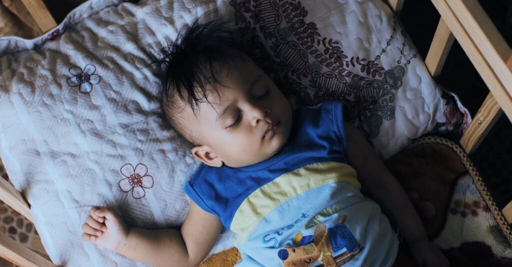 Toddler asleep in a crib