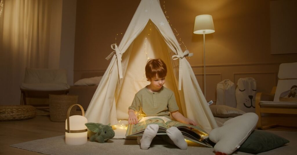 Child reading inside a lit teepee nook