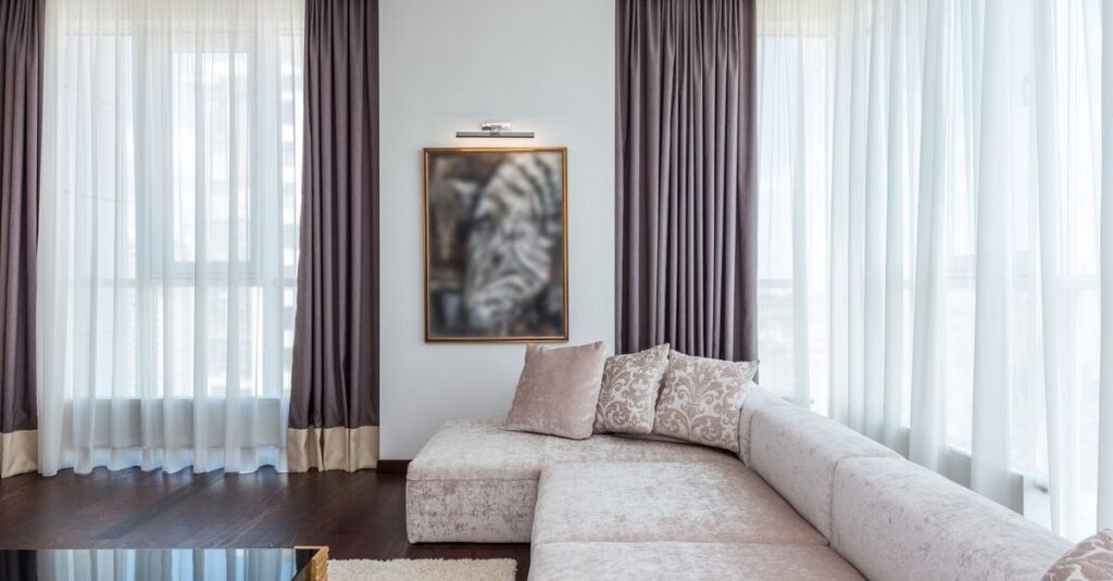 Floor-length curtains framing bright living room windows Floor-length curtains framing bright living room windows