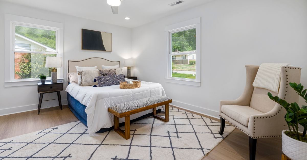 Bedroom with a rug extending beyond the sides of the bed