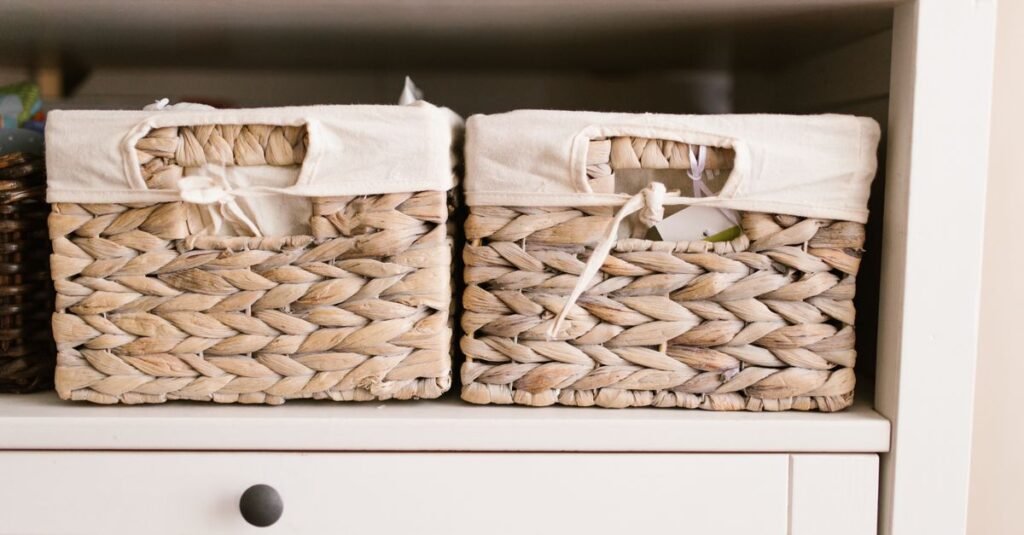 Woven baskets neatly arranged on a white nursery dresser