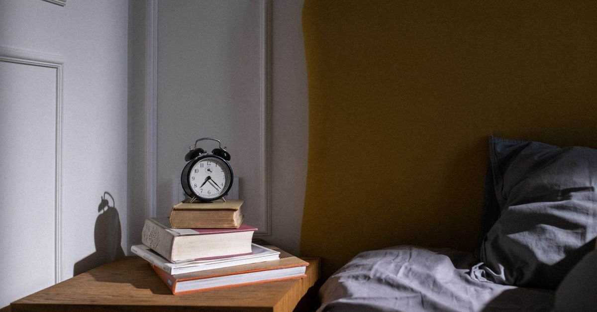 A nightstand at the right height beside a bed