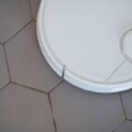 Robot mop autonomously cleaning a hard floor in a modern smart home
