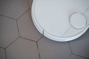 Robot mop autonomously cleaning a hard floor in a modern smart home