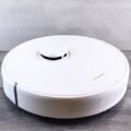 Robot vacuum autonomously cleaning a living room floor
