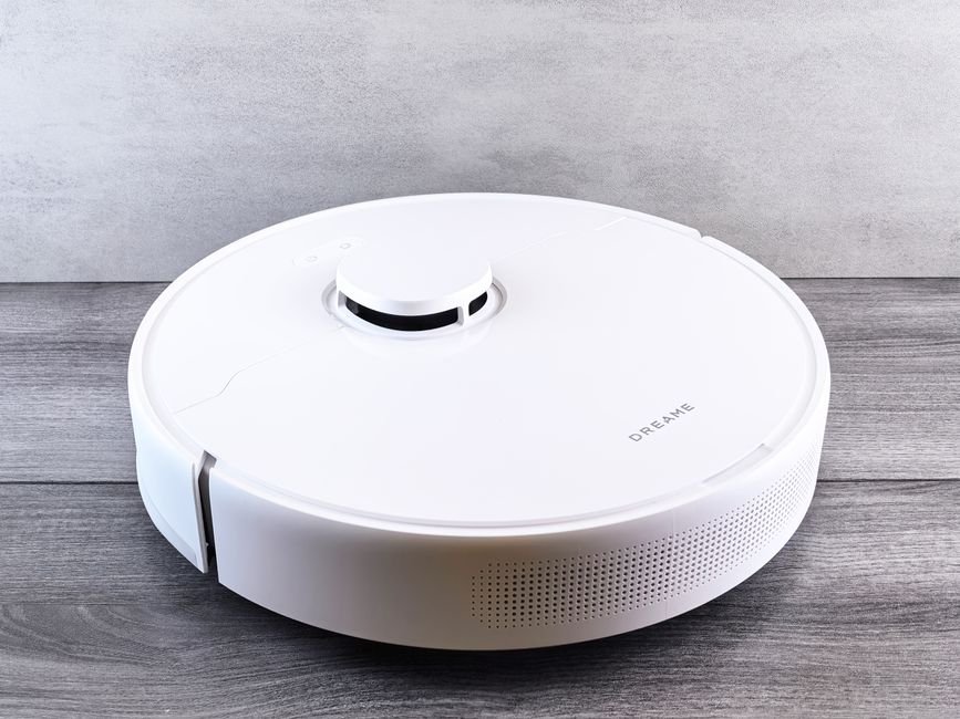 Robot vacuum autonomously cleaning a living room floor