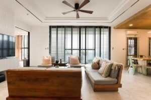 Slim tower fan cooling a bright, comfortable living room
