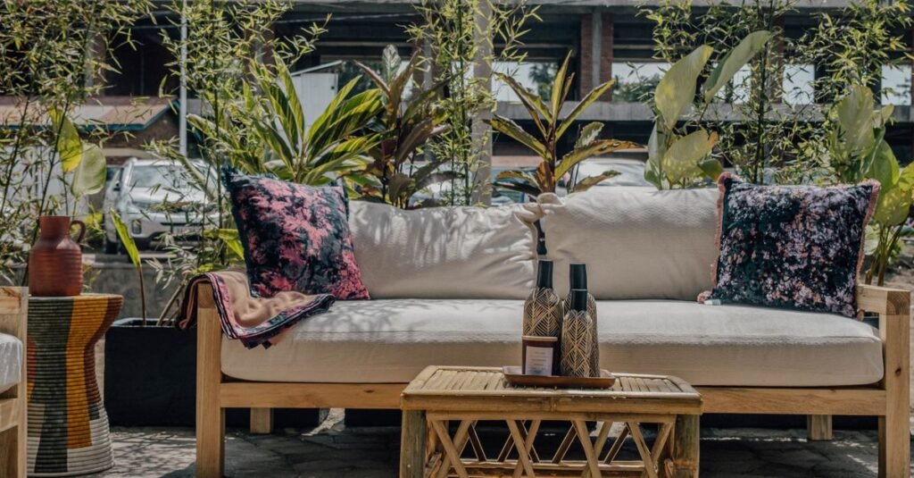 Outdoor sofa with layered rugs and cushions