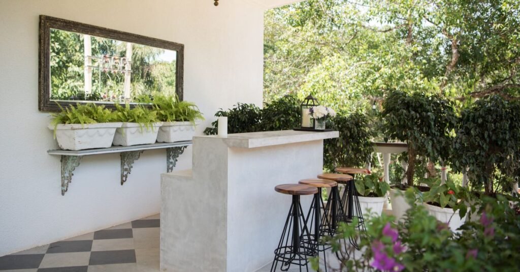 White outdoor bar counter with stools