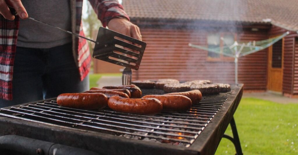 Backyard grilling with sausages on a kettle grill