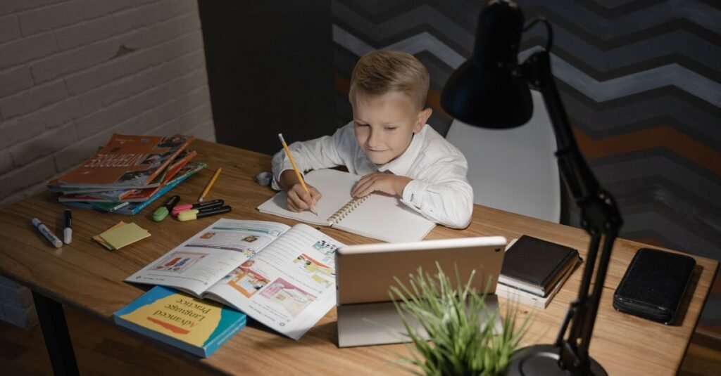 Child studying under a desk lamp in the evening