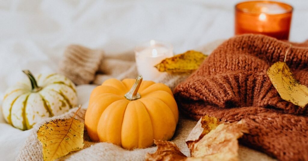 Pumpkin and autumn leaves on a chunky knit