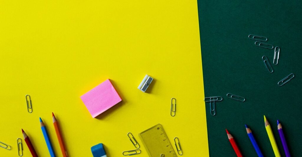 Bright school supplies on yellow and green