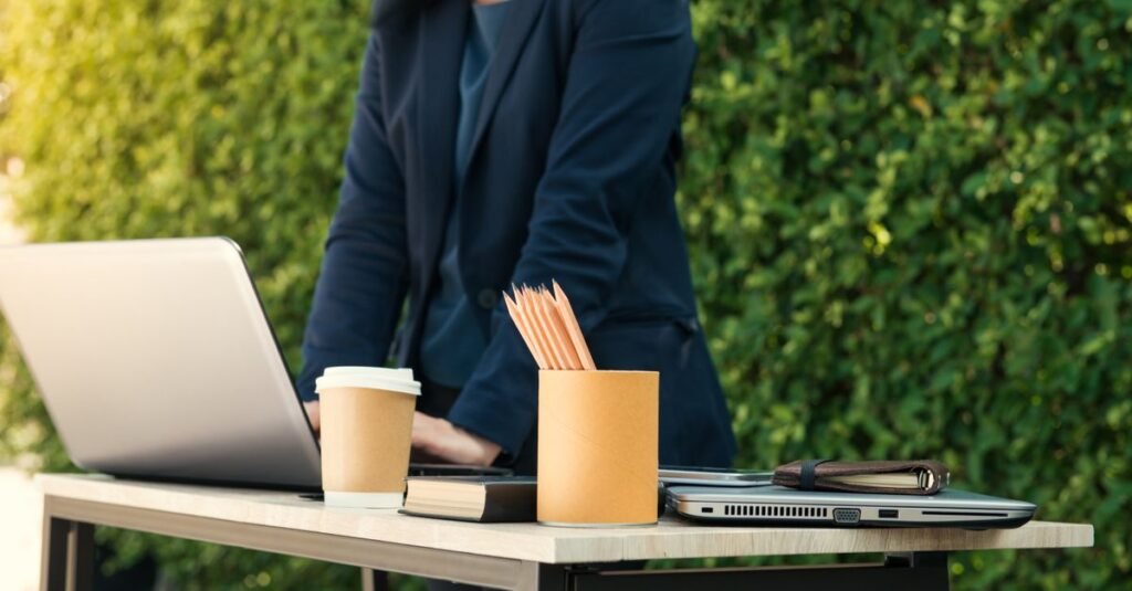 Laptop and pencil cup on an outdoor work table