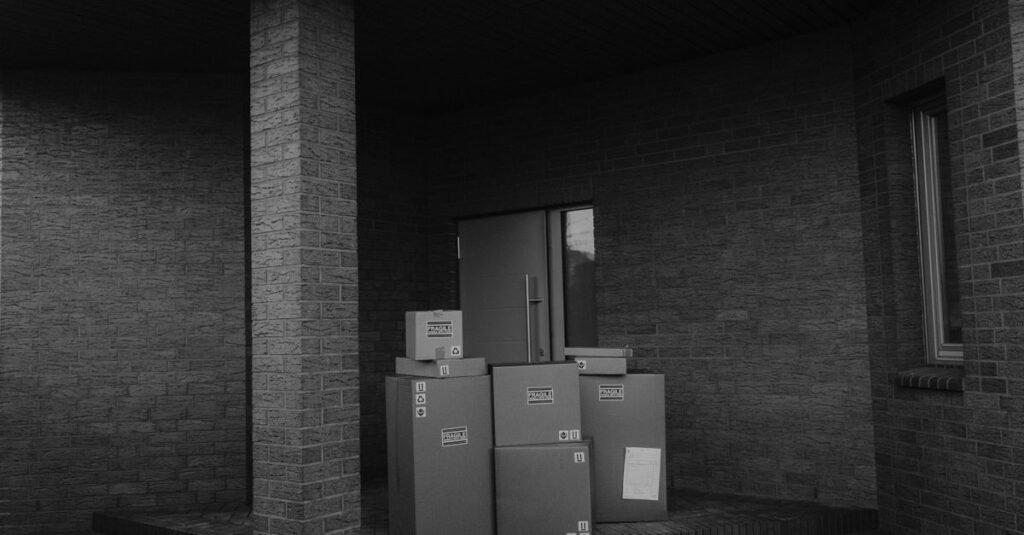 Parcels stacked in a dark entry alcove