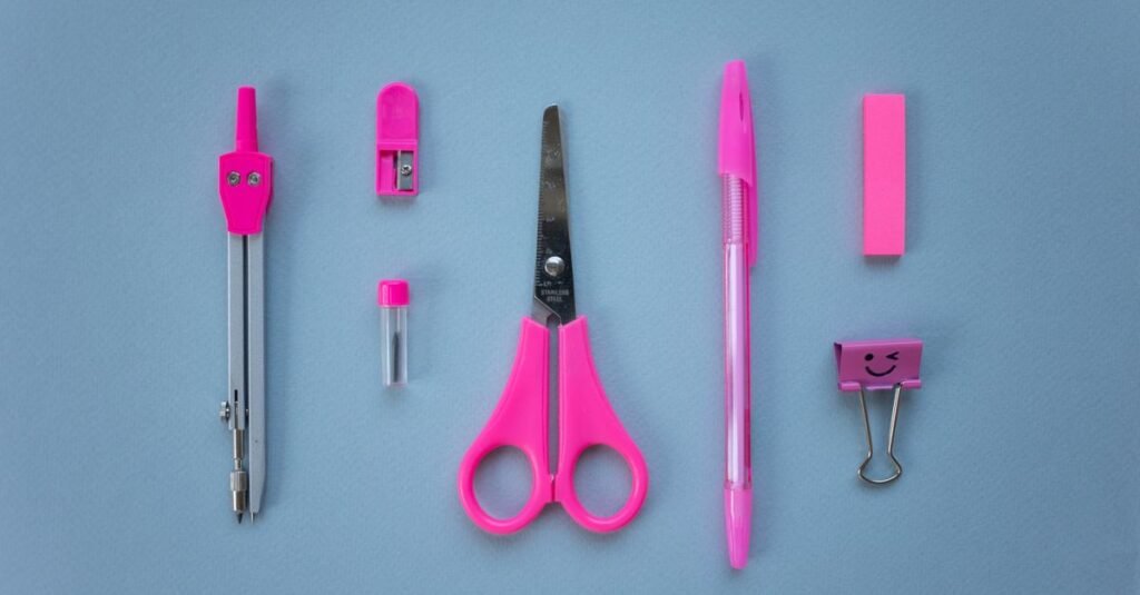 School supplies arranged on a grey background